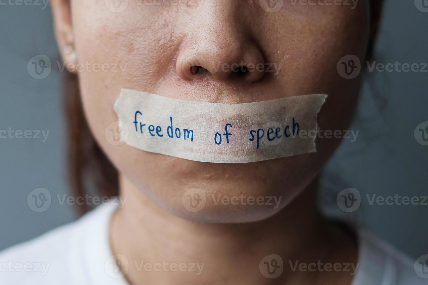 woman with mouth sealed in adhesive tape with Freedom  of Speech message., freedom of press, Human rights, Protest dictatorship, democracy, liberty, equality and fraternity concepts photo