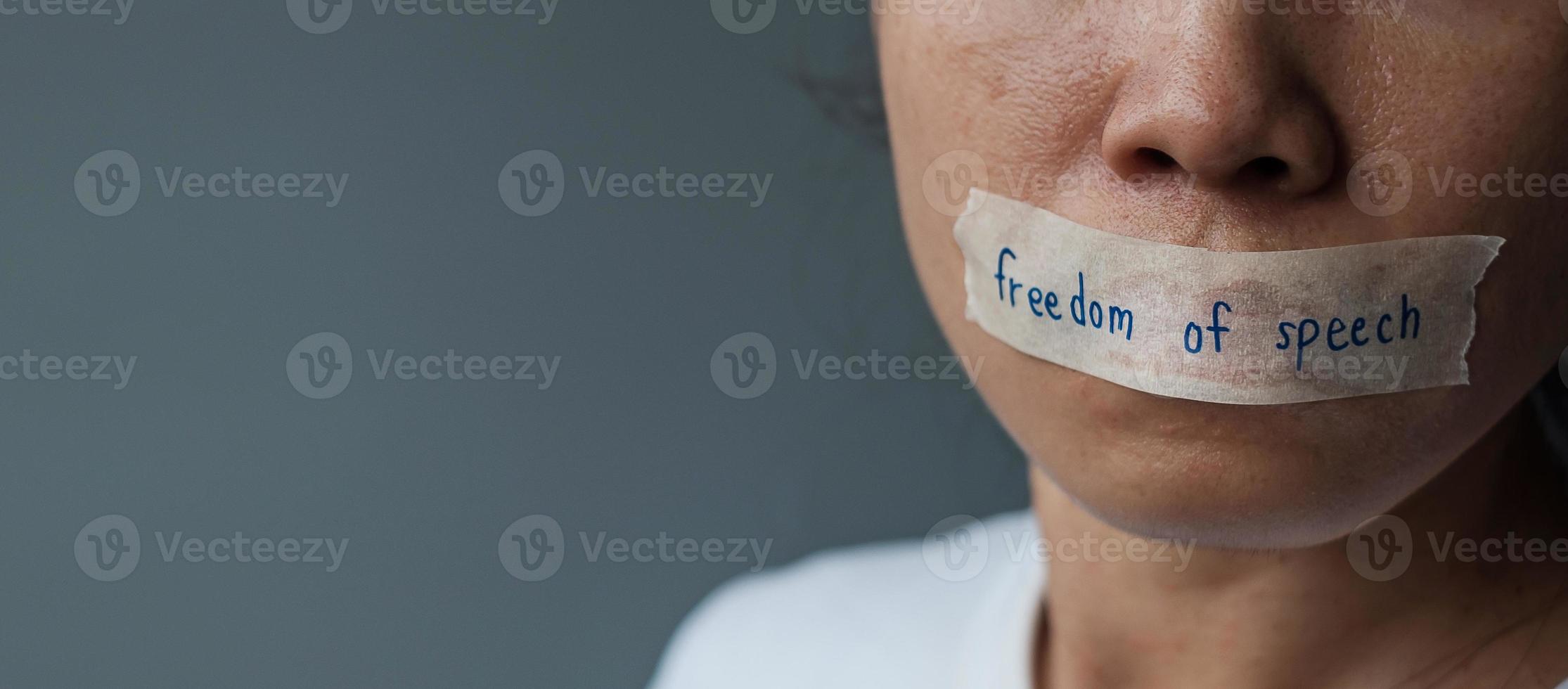 woman with mouth sealed in adhesive tape with Freedom  of Speech message., freedom of press, Human rights, Protest dictatorship, democracy, liberty, equality and fraternity concepts photo