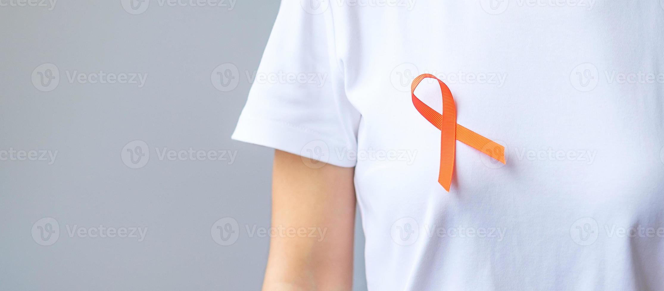 Orange Ribbon for Leukemia, Kidney cancer day, world Multiple Sclerosis, CRPS, Self Injury Awareness month. Healthcare and word cancer day concept photo