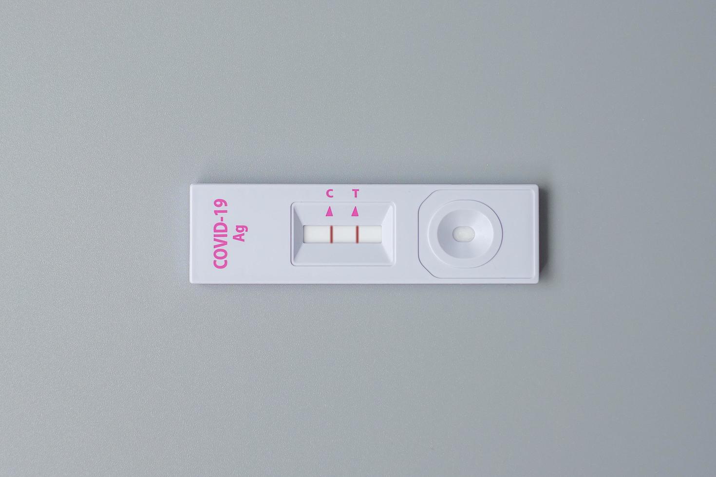 Rapid Antigen Test kit with Positive result during swab COVID-19 testing. Coronavirus Self nasal or Home test, Lockdown and Home Isolation concept photo