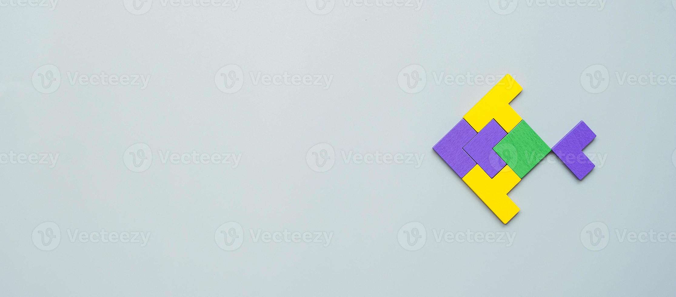 Fish shape block of colorful wood puzzle piece on gray background. logical thinking, business logic, Conundrum, decision, solutions, rational, mission, success, goals and strategy concepts photo