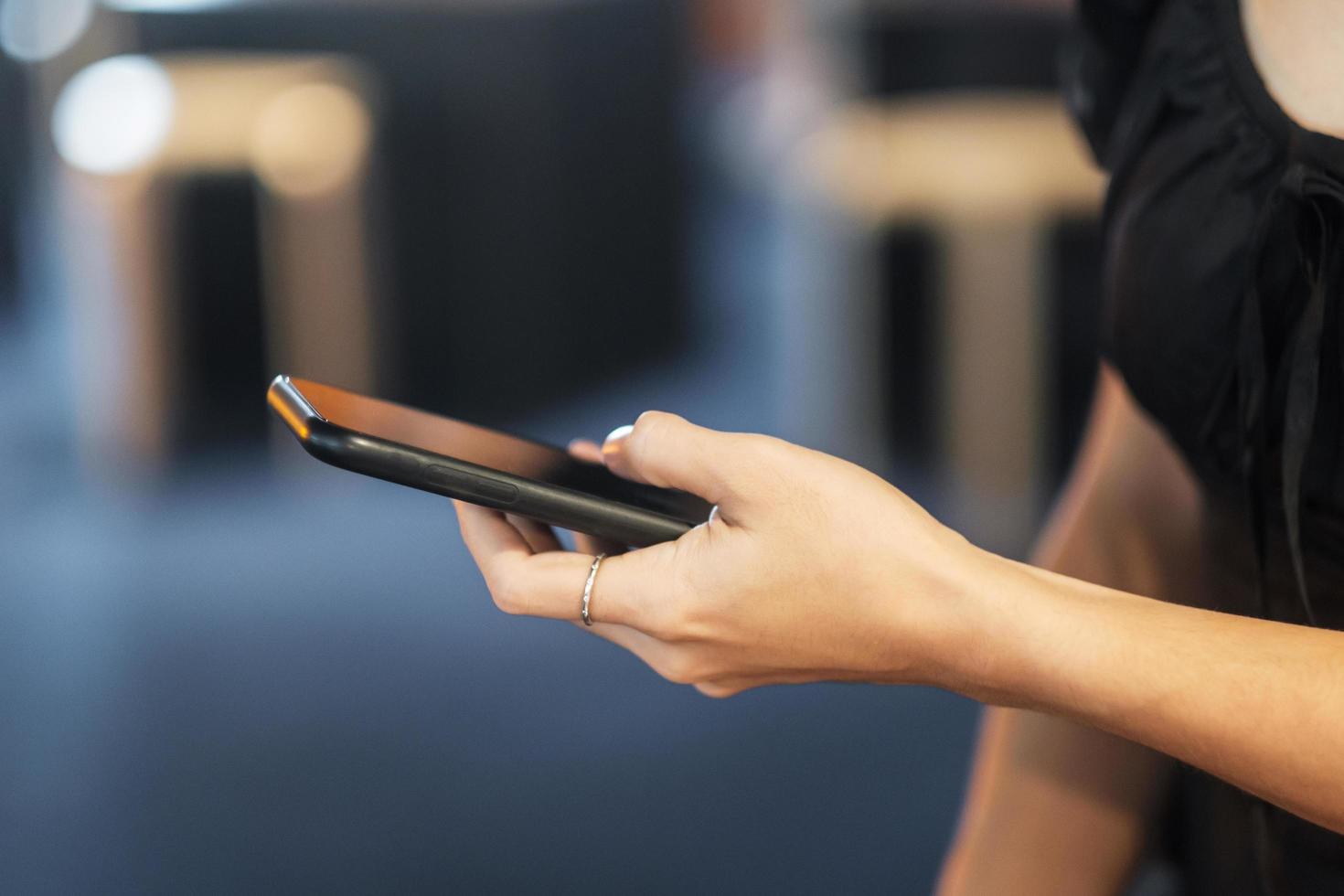 smartphone for sms messages, young woman typing touchscreen mobile phone in cafe or modern office. lifestyle, technology, Social media and network concept photo