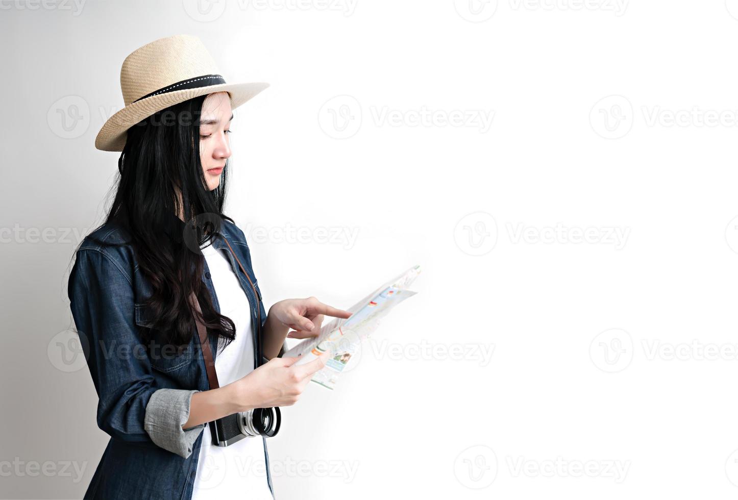 Asian woman holding map for travel plan photo