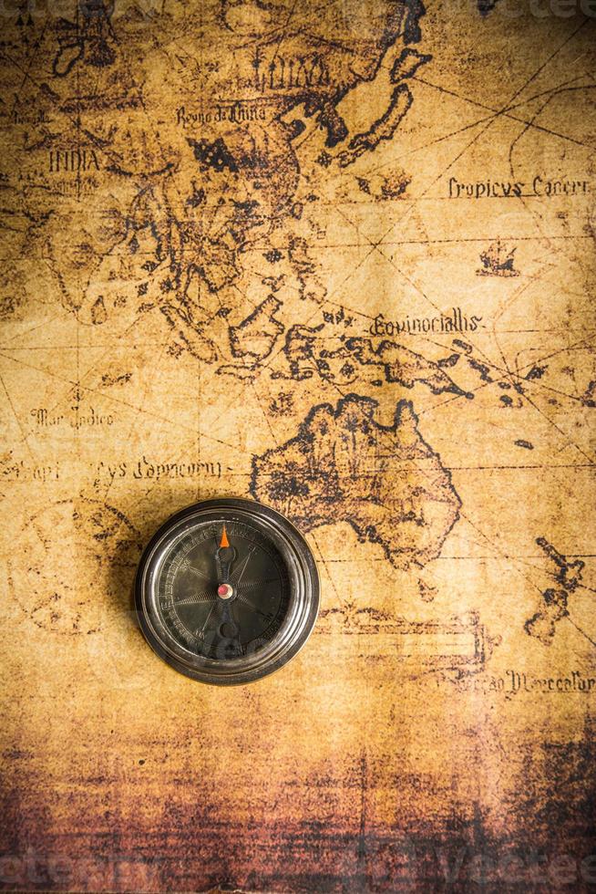 Old vintage retro compass on ancient map.The map used for background is in Public domain. photo