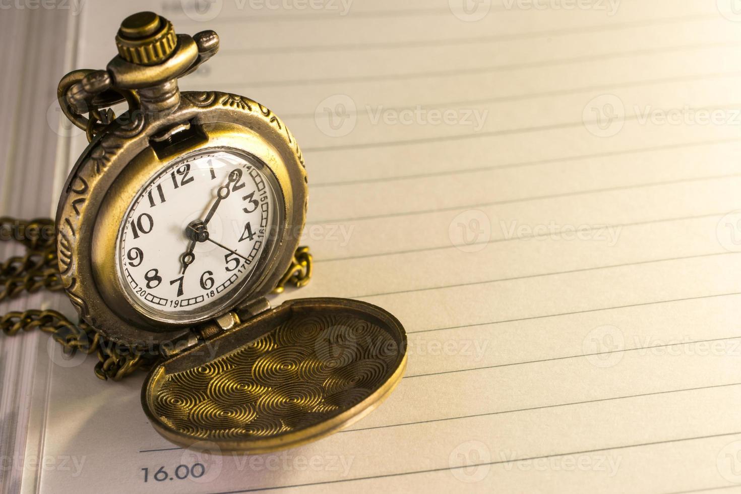 pocket watch  selective focus . Focus area are the dial of the clock picture style old image photo