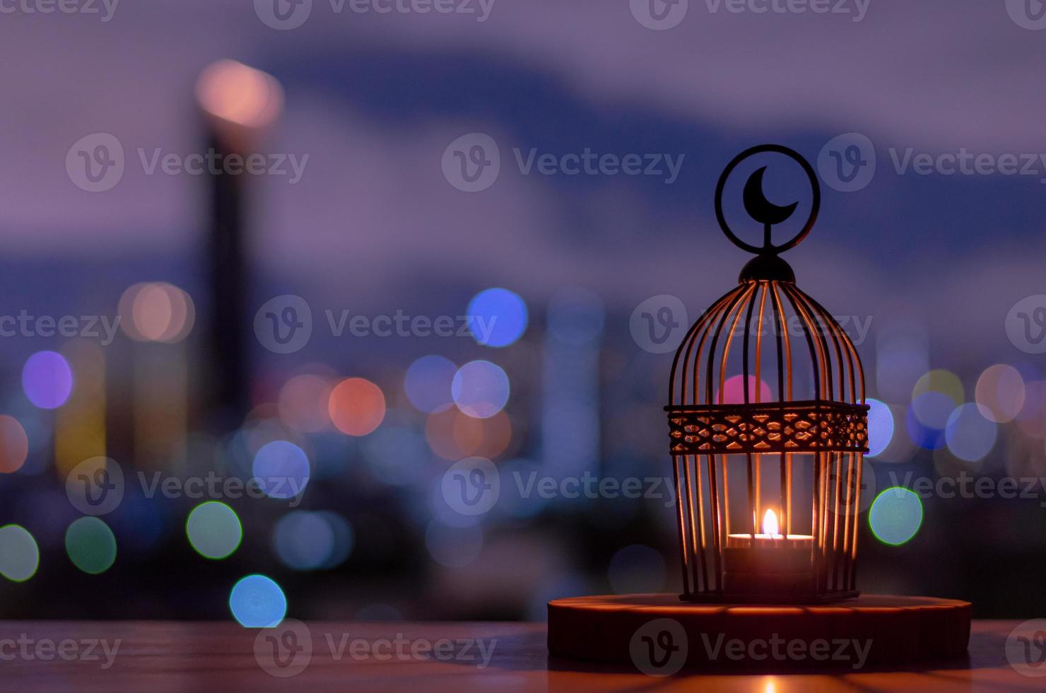 Lantern that have moon symbol on top with dusk sky and city bokeh light background. photo