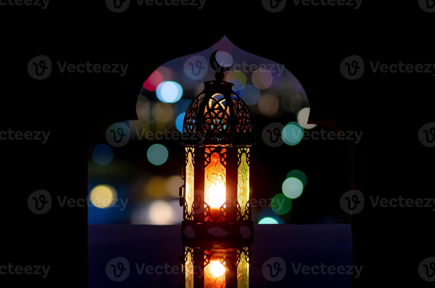 Lantern that have moon symbol on top with city bokeh light photo