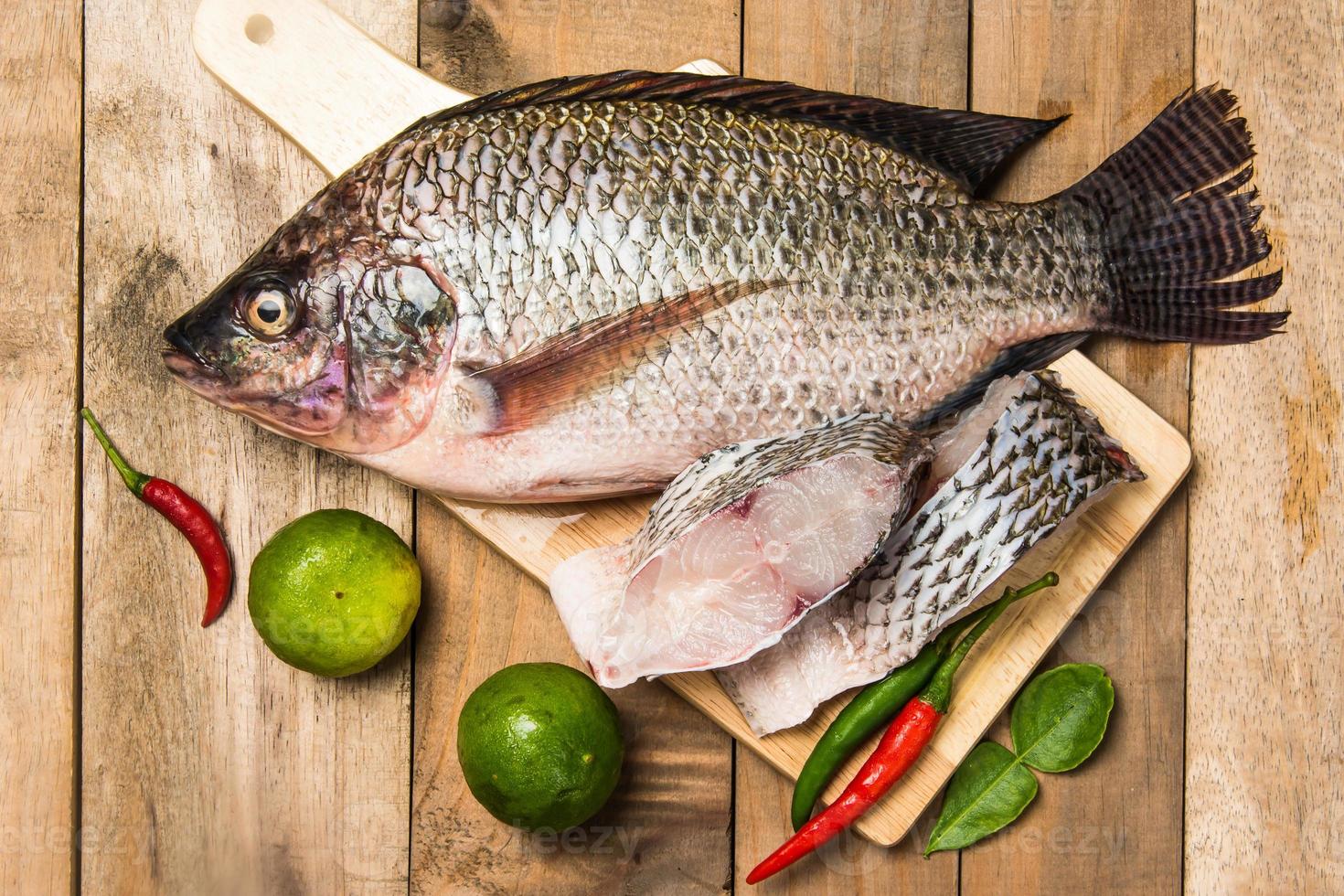 Fresh raw fish on the wood photo