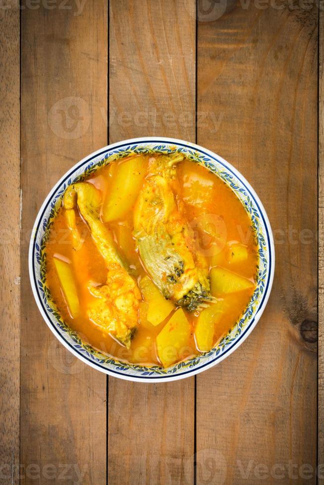 Southern Thai Spicy Sour Yellow Curry with Sea Bass and Coconut Shoots, Sour soup made of Tamarind Paste or Turmeric. photo