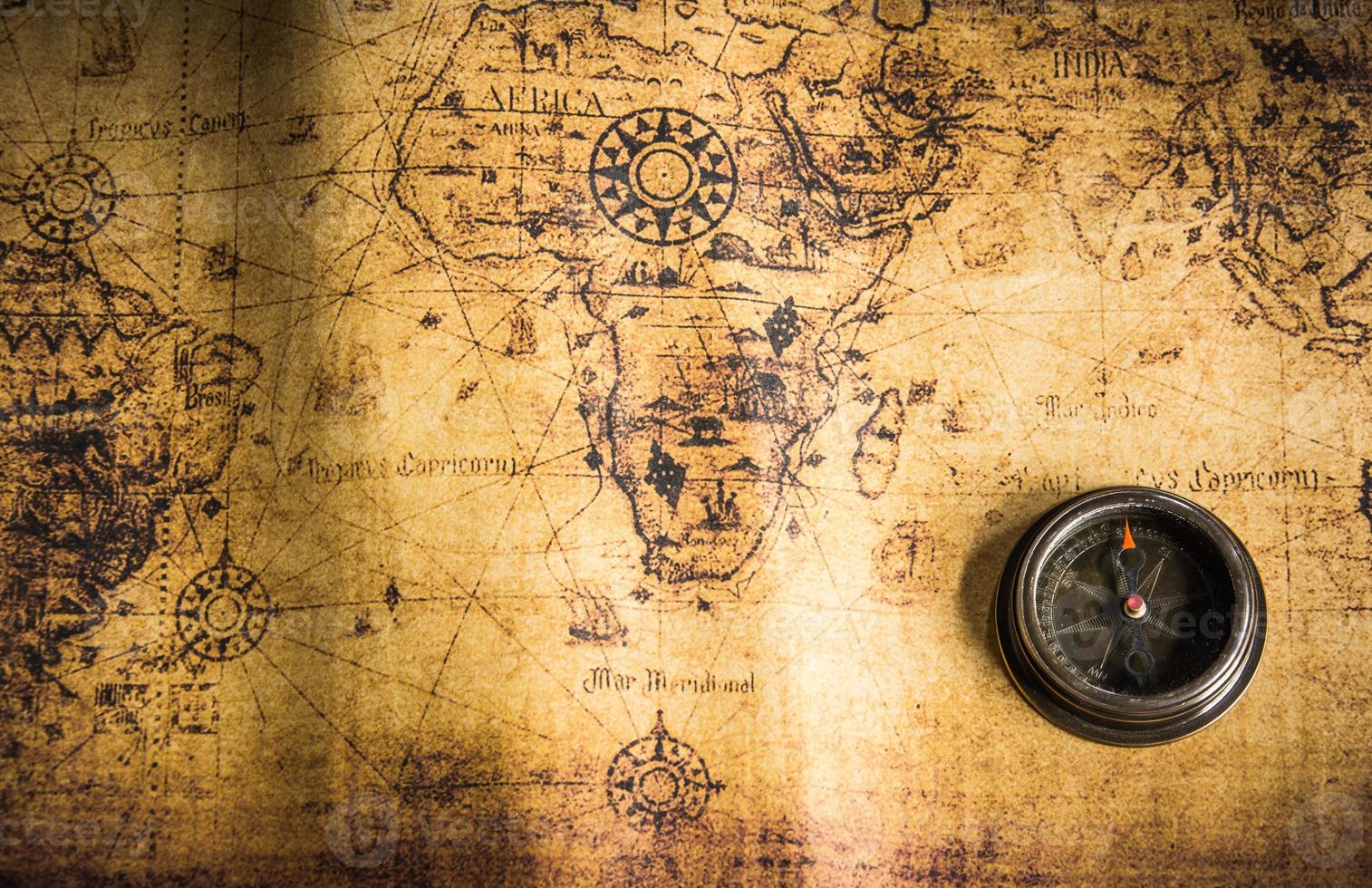 Old vintage retro compass on ancient map.The map used for background is in Public domain. photo