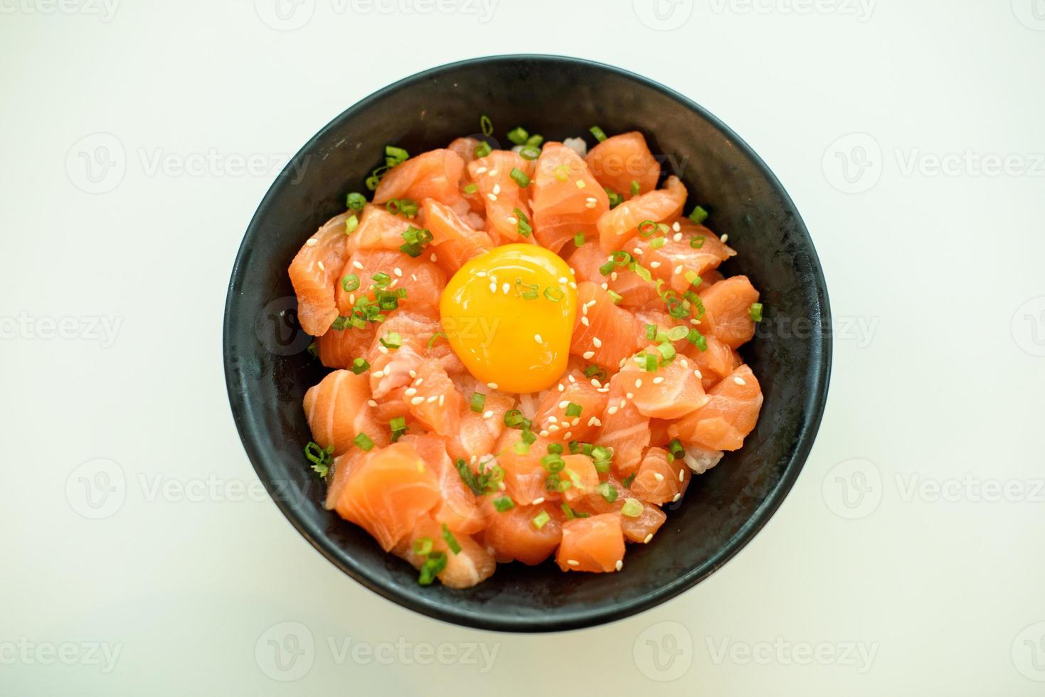 Salmon with egg rice in a black bowl on a white background photo