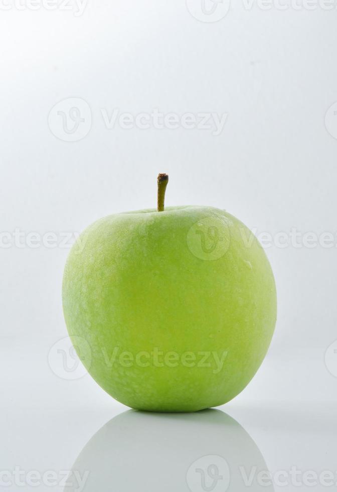 una manzana verde sobre un fondo blanco foto