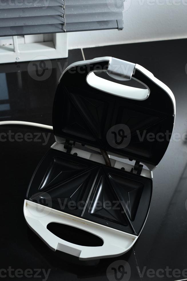 The toaster opens and closes the lid. photo