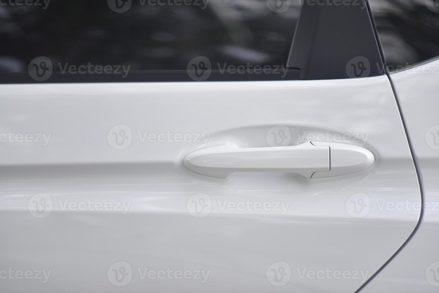 close up of white car door handle photo