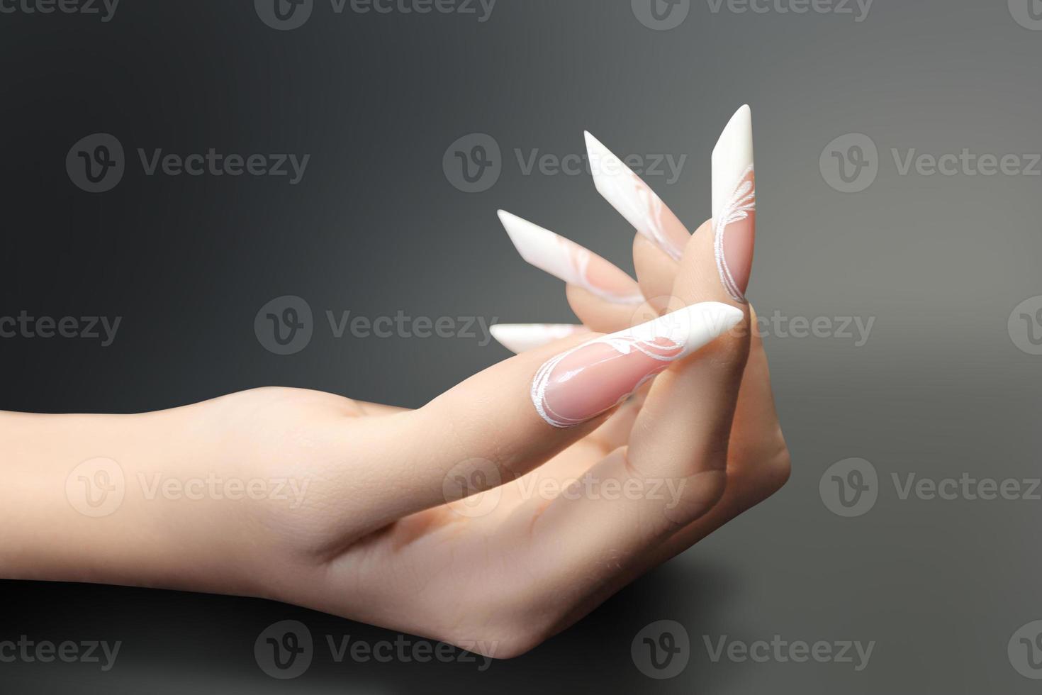 Young beautiful woman hands with elegant manicure photo