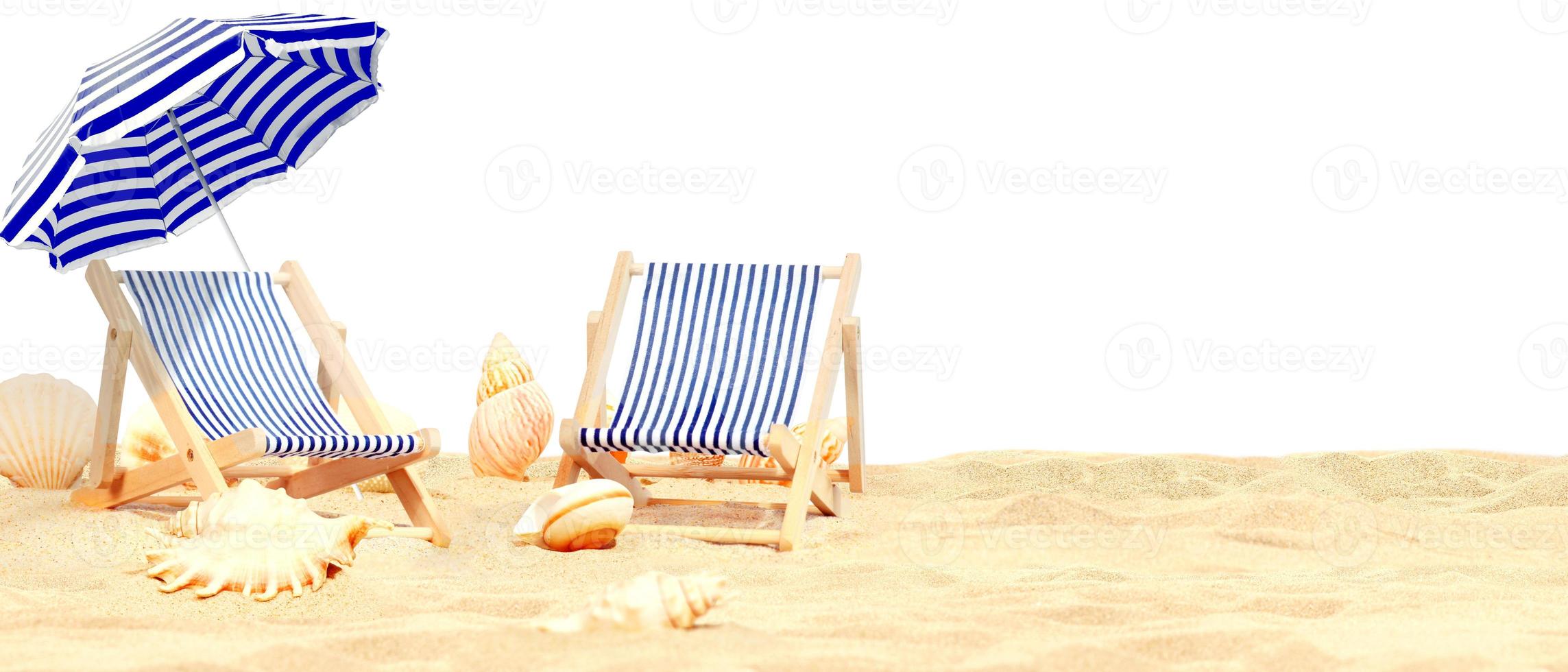 Relax on tropical beach in the sun on deck chairs under umbrella. photo