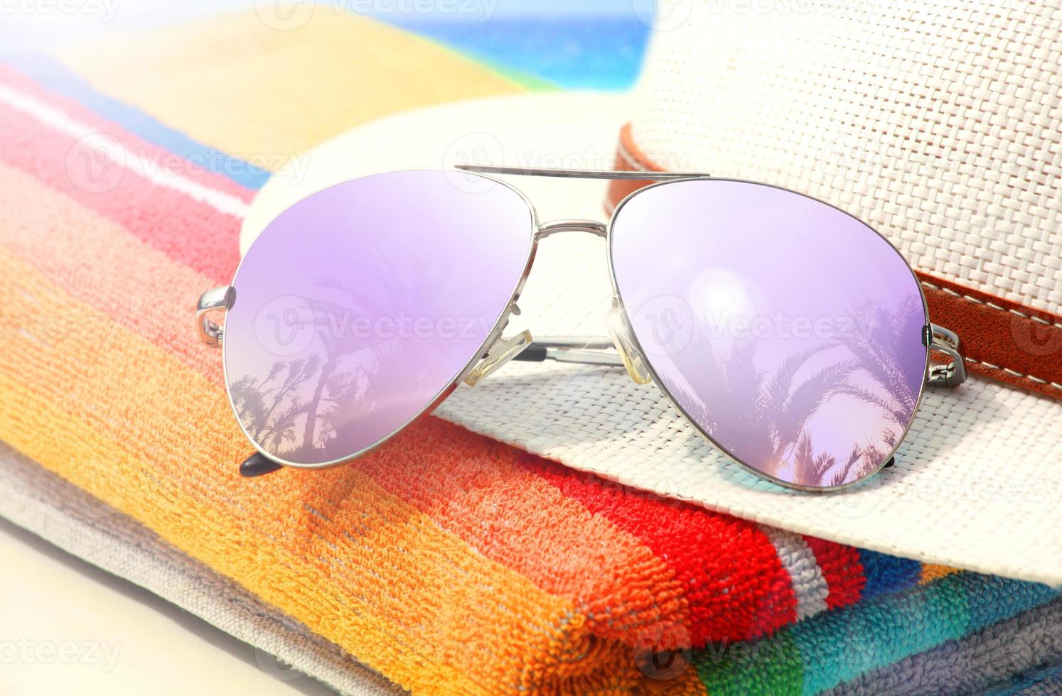 Summer tropical beach background with sunglasses and hat. photo