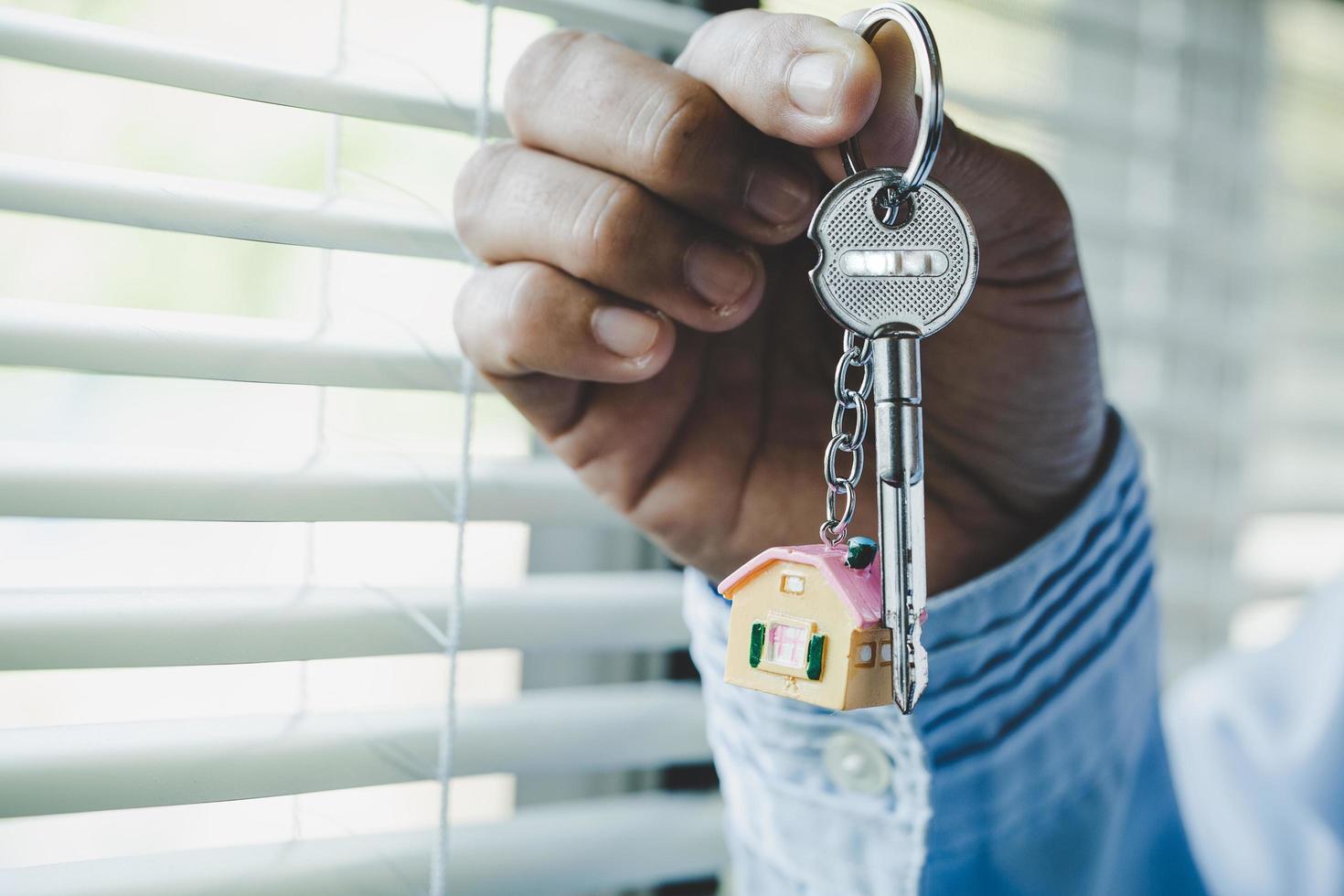 Real estate agent handing over a house key photo