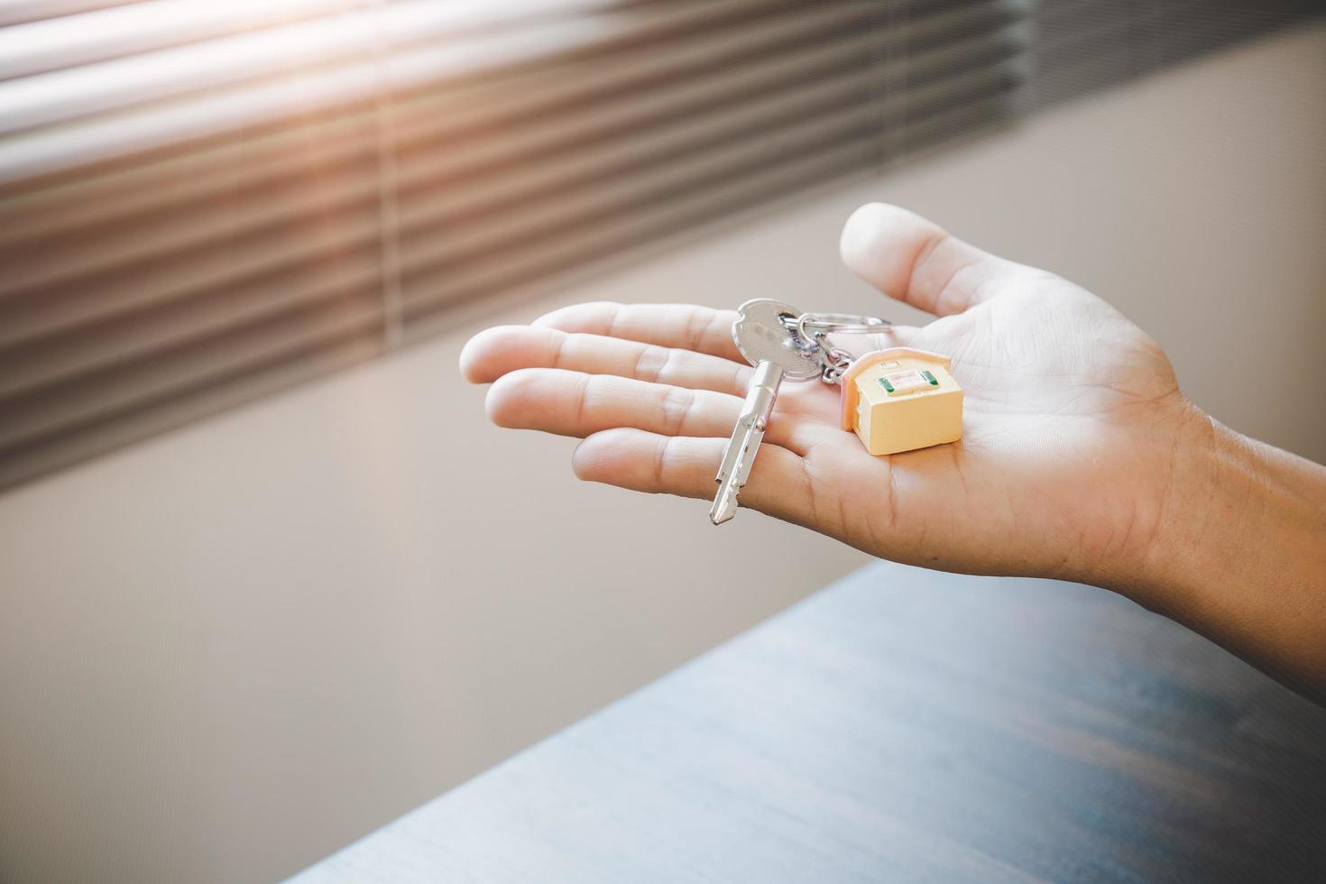 Real estate agent handing over a house key photo