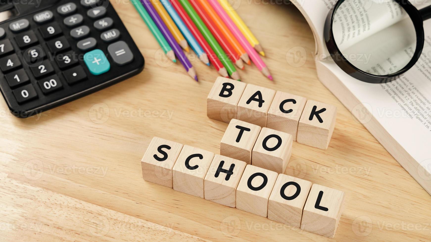 School supplies on wooden table background. Back to school concept. photo