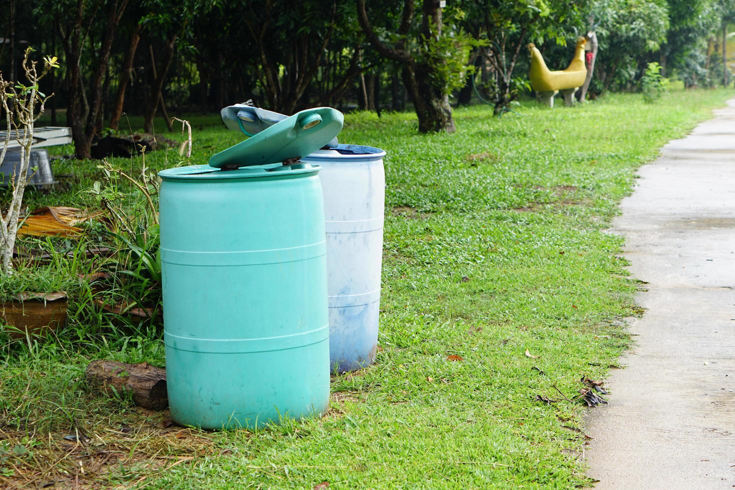 Two trash bins on the side of the road. photo