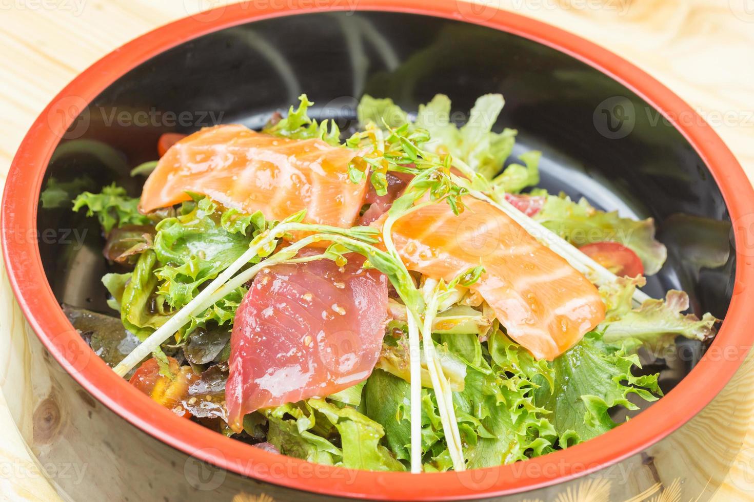 Salmon Salad with spinach, cherry tomatoes, corn salad, baby spinach, fresh mint and basil. Home made food. Concept for a tasty and healthy meal. Dark stone background. Top view. Close up. photo