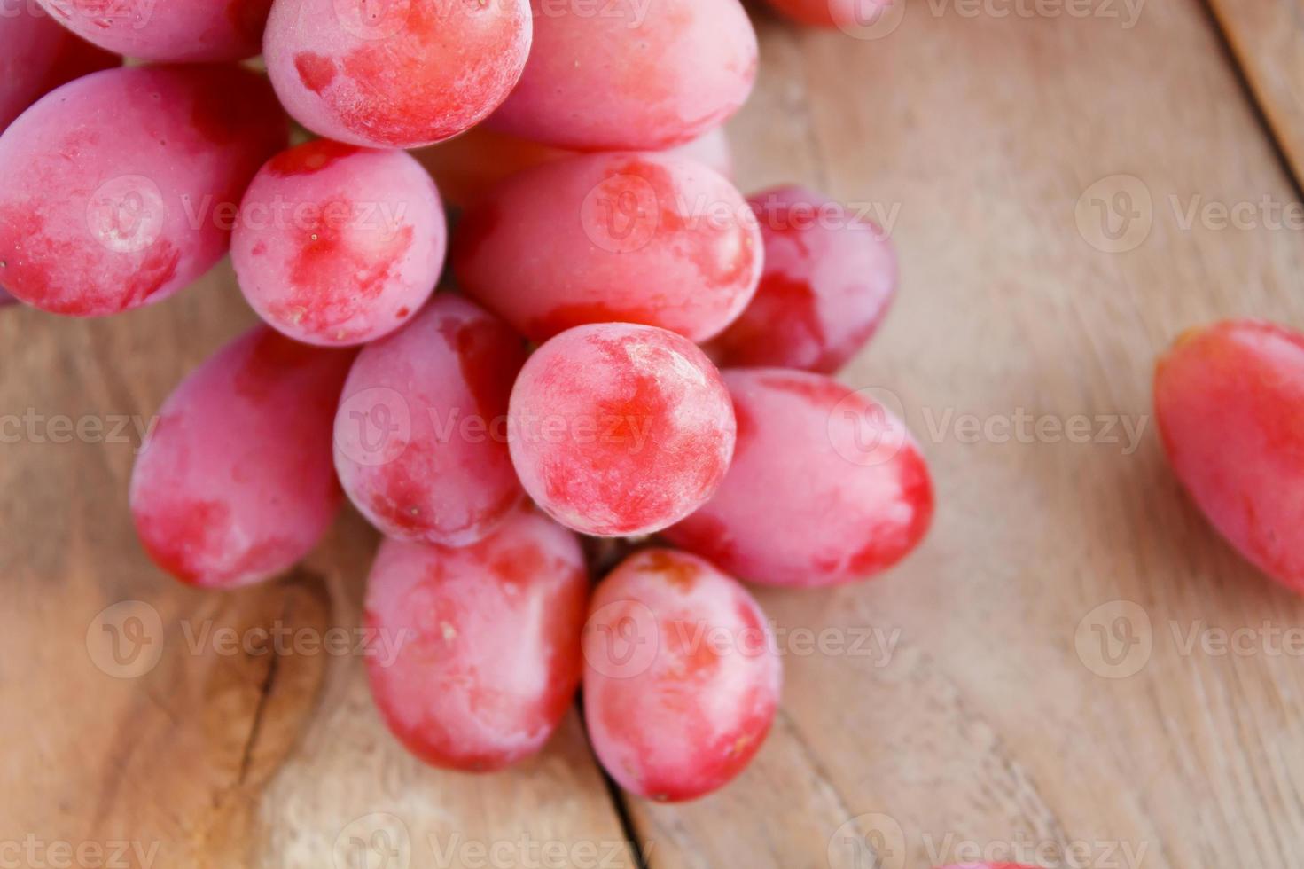 red grapes on wooden background photo