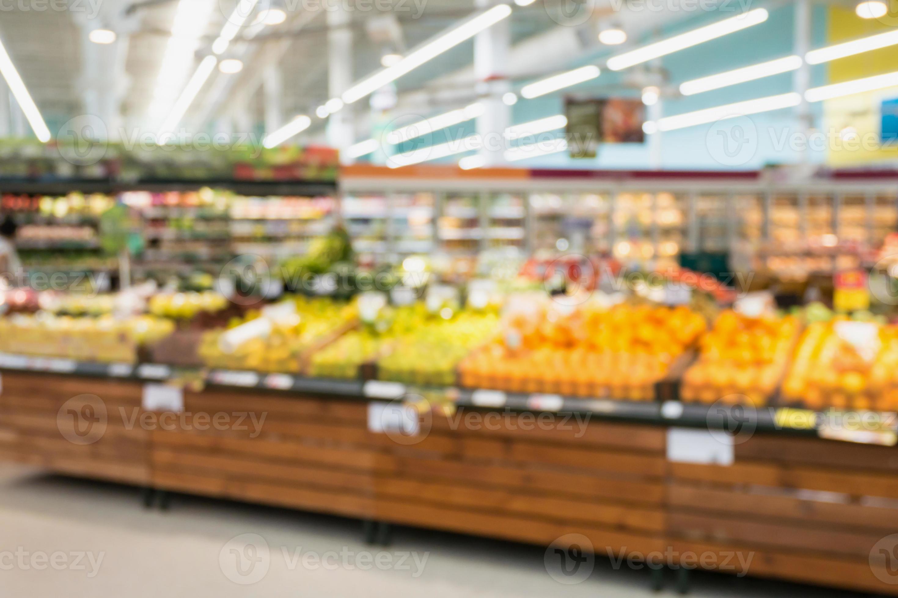 Supermarket grocery store with fruit and vegetable on shelves blurred