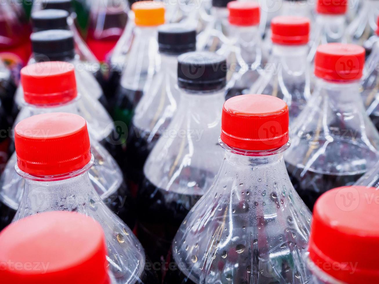 Carbonated soft drink bottles close up photo