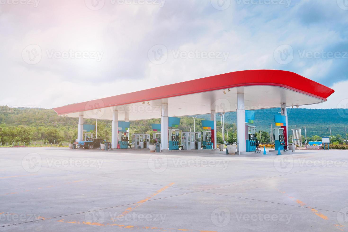 Gas fuel station with clouds in the sky and sun light photo