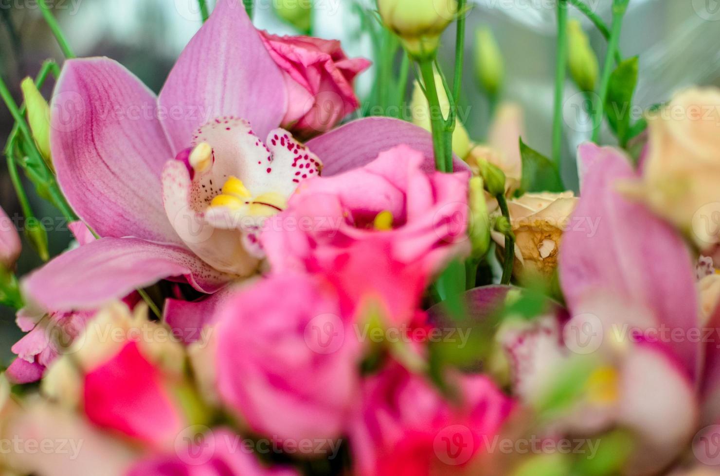 Bouquet with orchids and roses on a beautiful background photo