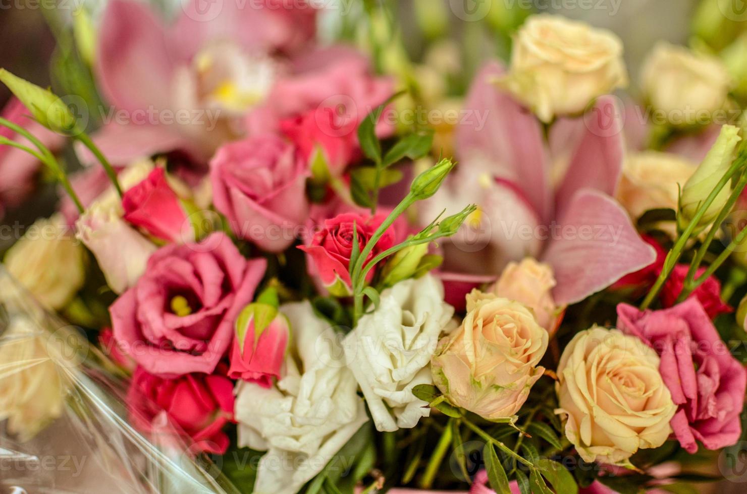 Bouquet with orchids and roses on a beautiful background closeup photo