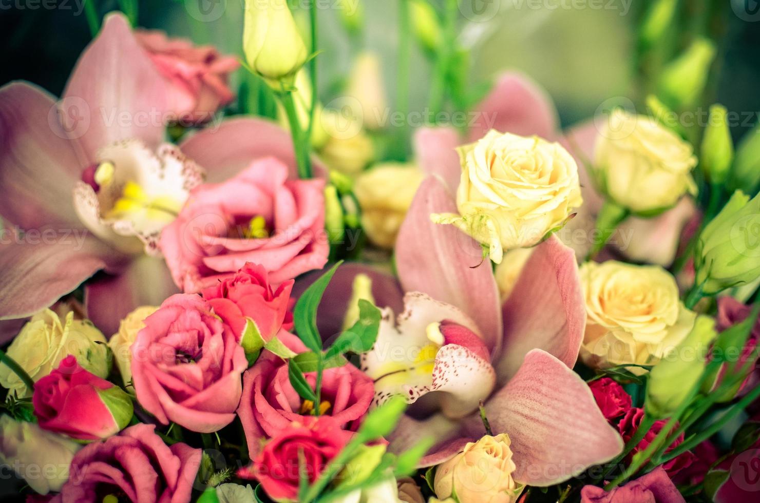 Bouquet with orchids and roses on a beautiful background photo