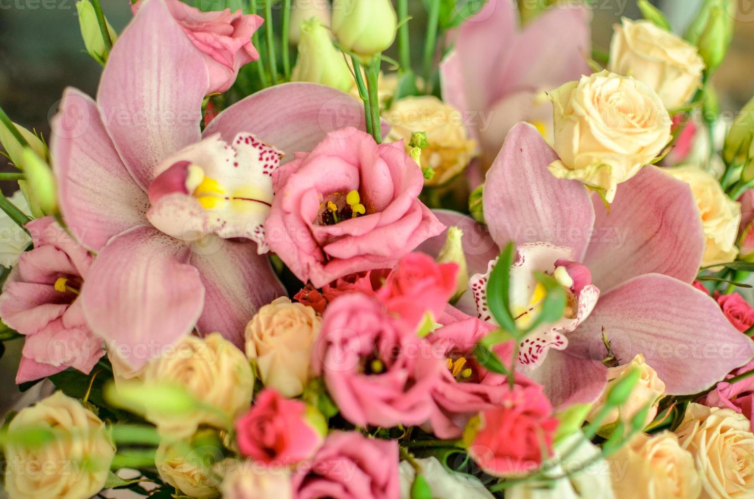 Bouquet with orchids and roses on a beautiful background photo