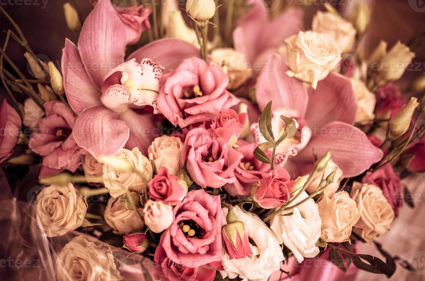 Bouquet with orchids and roses on a beautiful background closeup photo