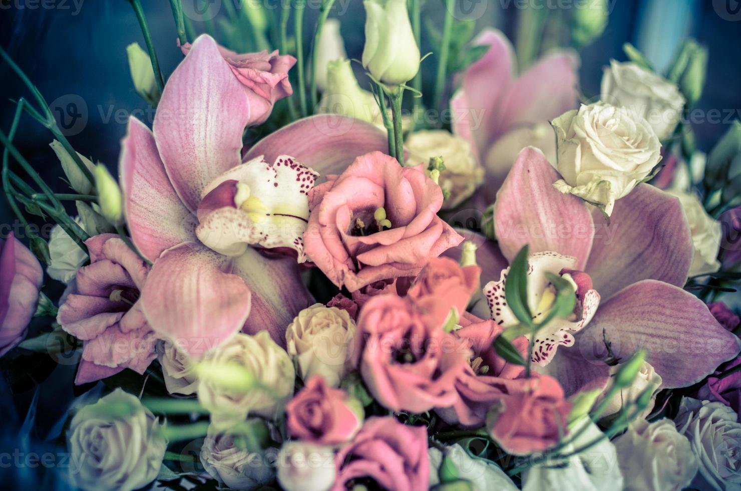 Bouquet with orchids and roses on a beautiful background photo