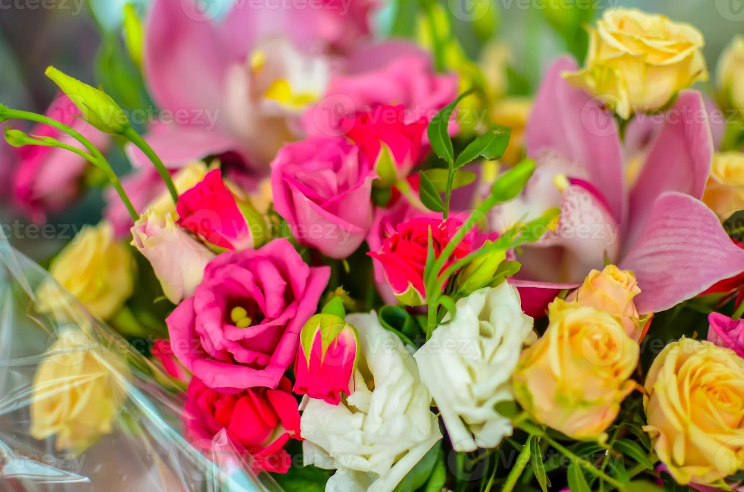 Bouquet with orchids and roses on a beautiful background photo
