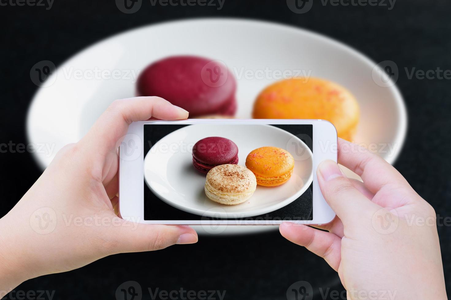 Colorful macarons with phone photo