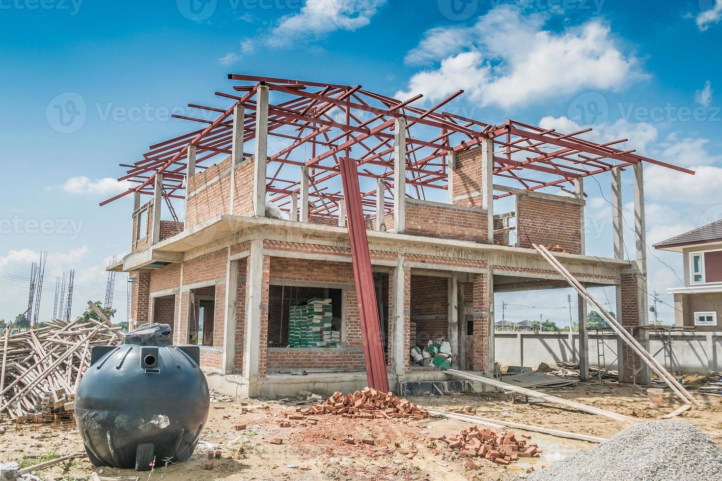 house building structure at construction site with clouds and blue sky photo