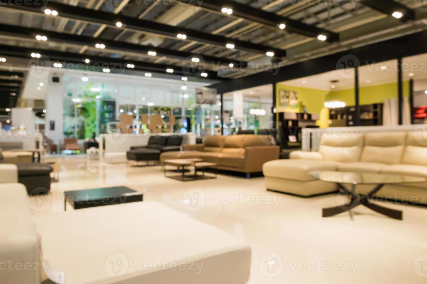 Abstract blur sofa in furniture showroom store interior with bokeh light background for montage product display photo