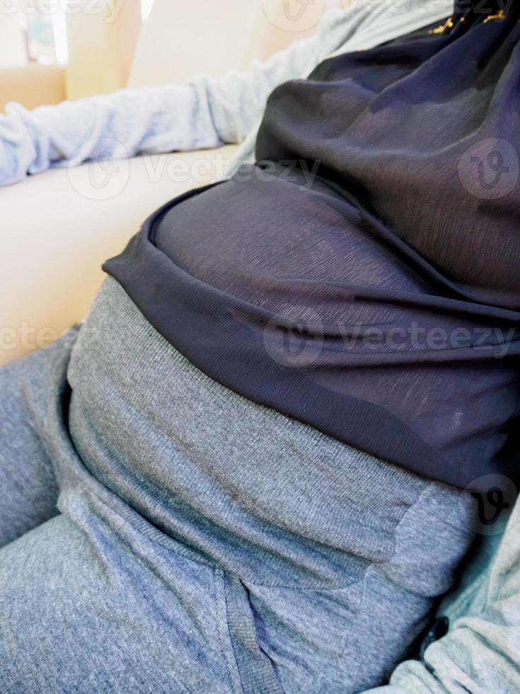 Pregnant woman sitting at sofa in the hospital photo