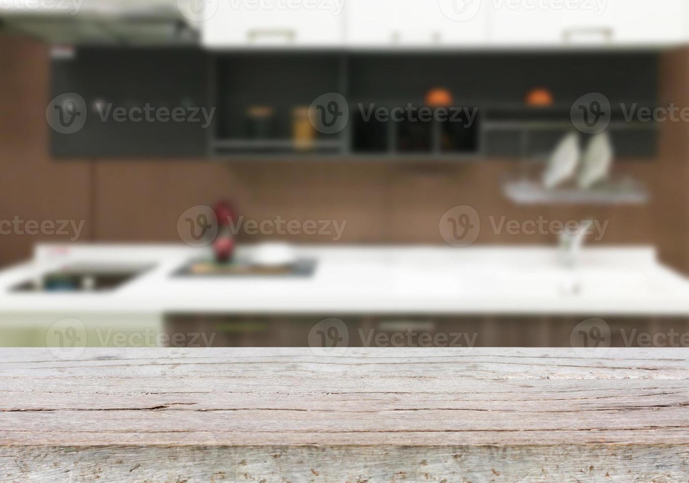 Empty wooden table and blurred kitchen background photo