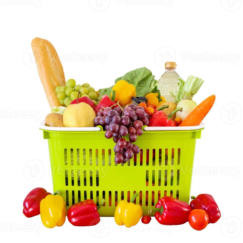 Fresh fruits and vegetables grocery product in green shopping basket isolated on white background photo