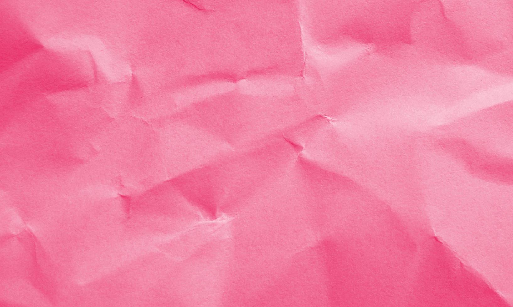 neon red colored crumpled paper texture background for design, decorative. photo