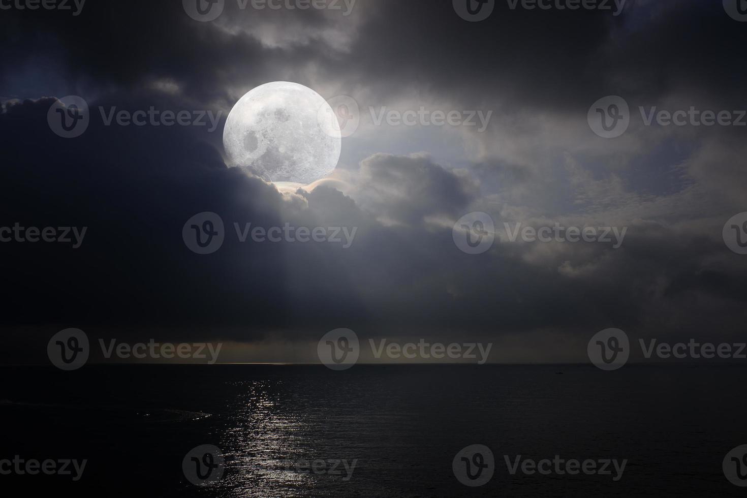 Romantic and scenic panorama with full moon on the sea at night. photo