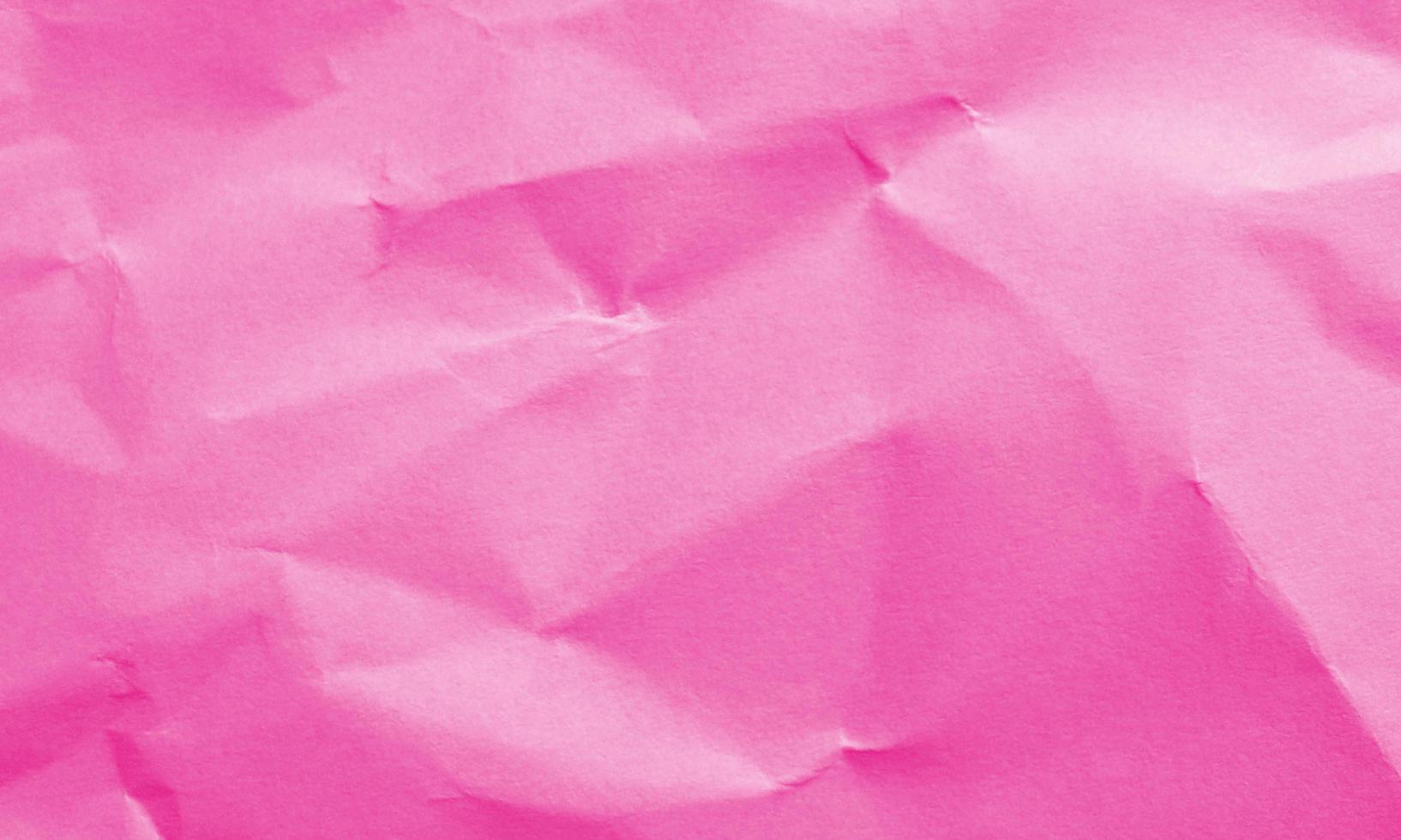 magenta colored crumpled paper texture background for design, decorative. photo