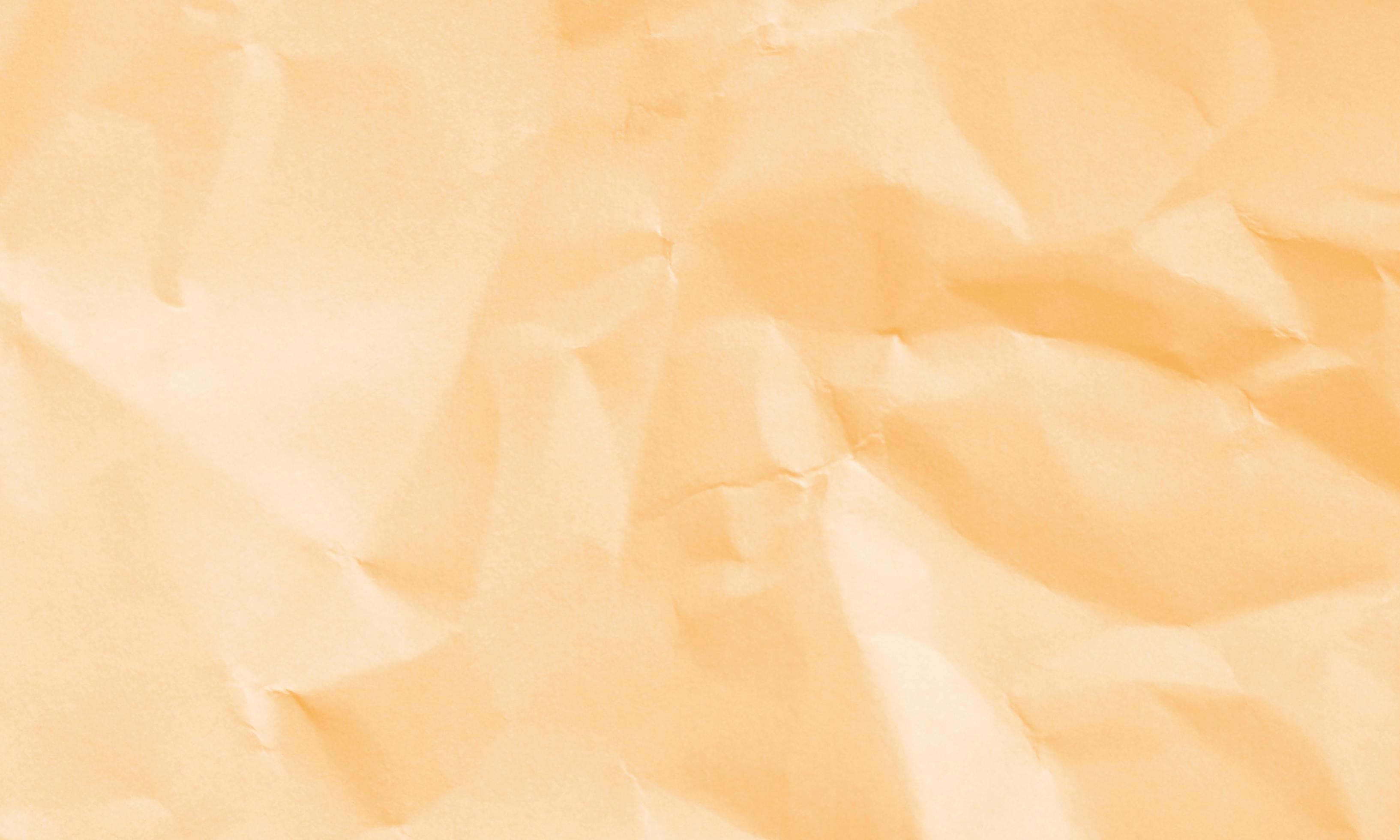 light orange colored crumpled paper texture background for design