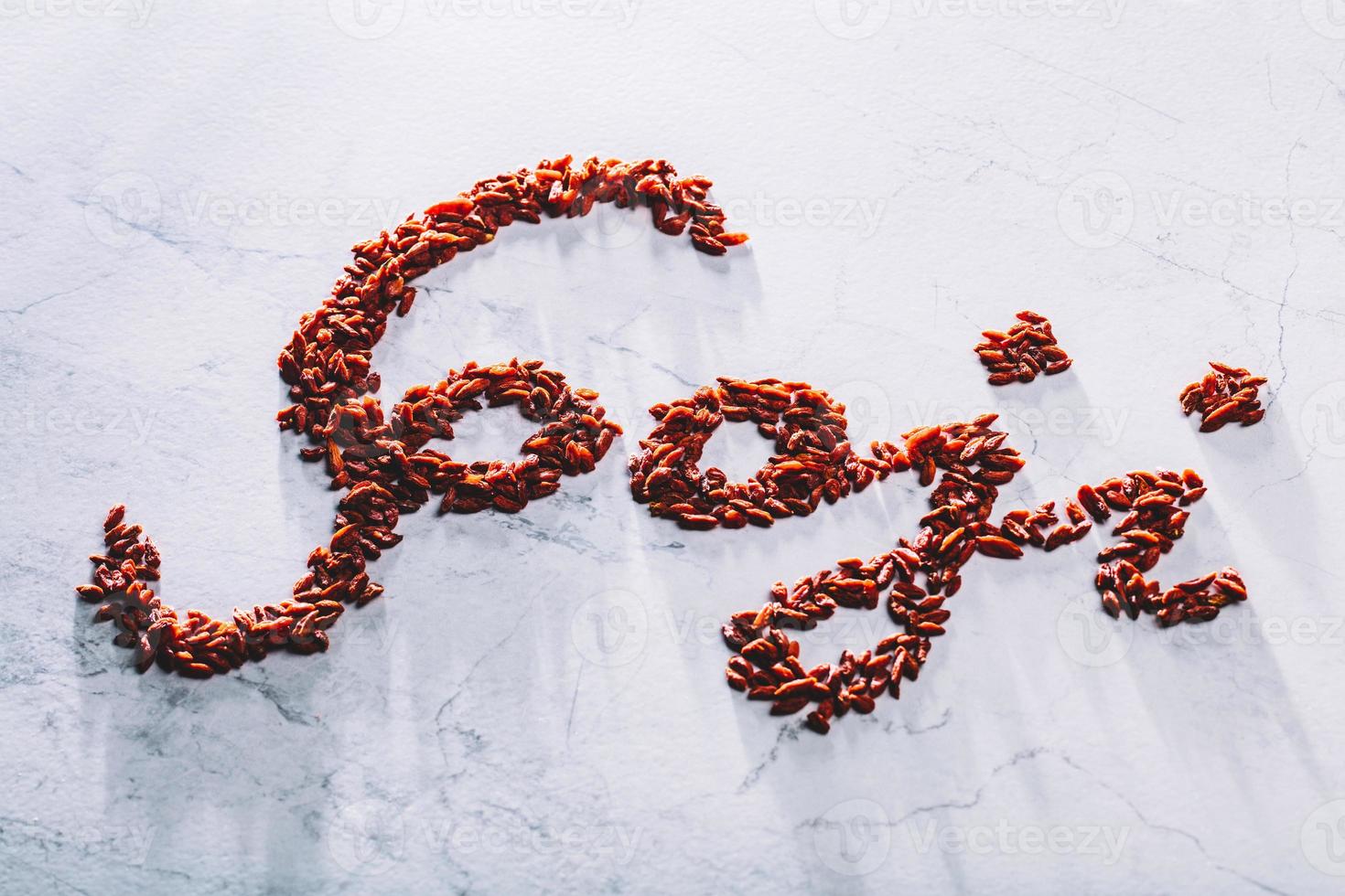 Goji word composed of little red goji berries. photo