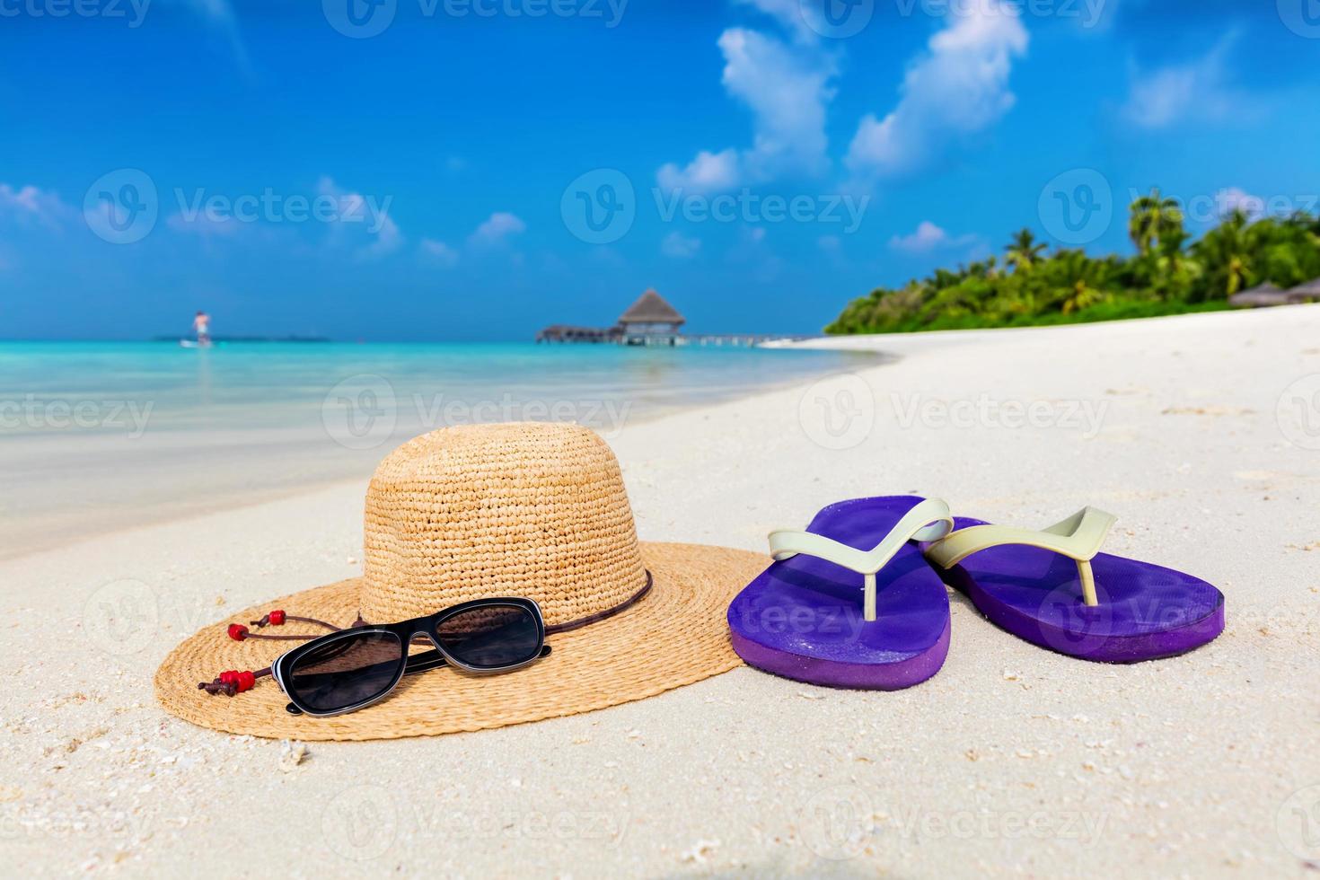 Beach accessories on sand, clear turquoise ocean in Maldives photo