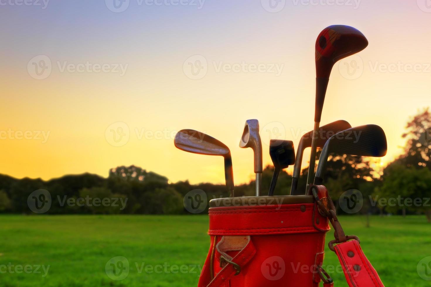 Golf equipment. Professional golf clubs at sunset photo